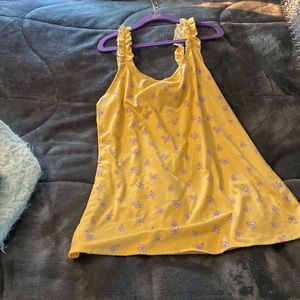 A yellow girls tank top:) with floral designs